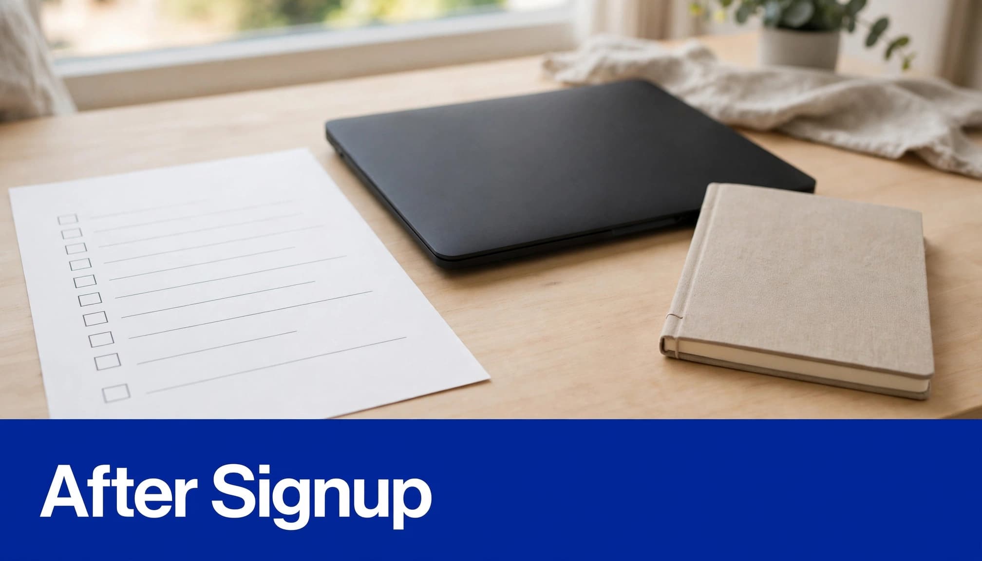 An onboarding checklist beside a closed laptop and notebook.